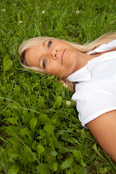 young woman lying on a lawn