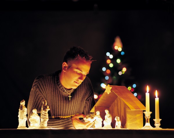 man with nativity scene figurines and