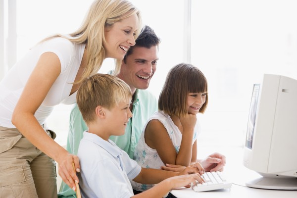 family in home office using computer