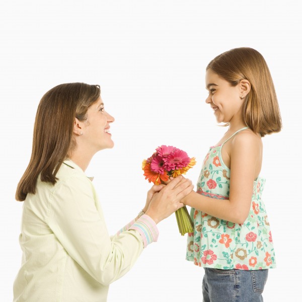 daughter giving mother flowers