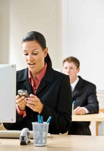 businesswoman text messaging on cell phone