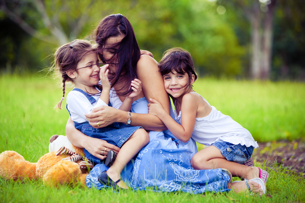 mother and two daughters playing in