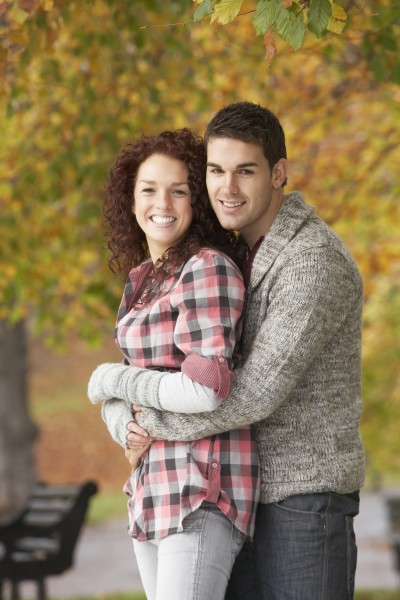 romantic teenage couple in autumn park
