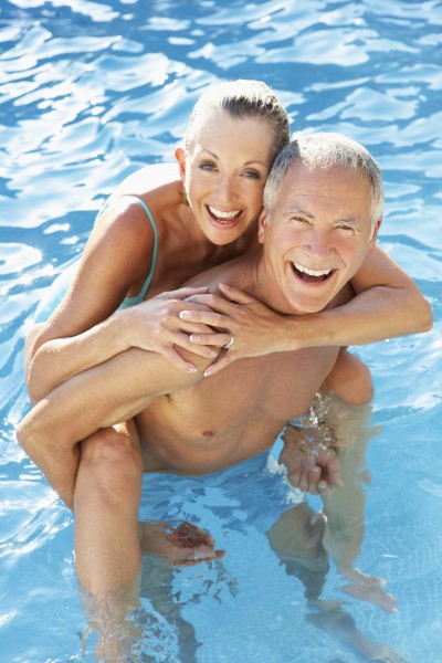 senior couple having fun in pool