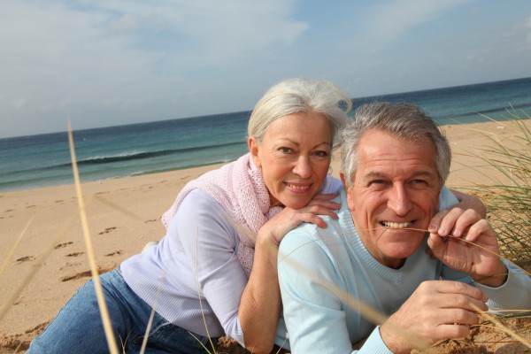 happy senior couple at the beach