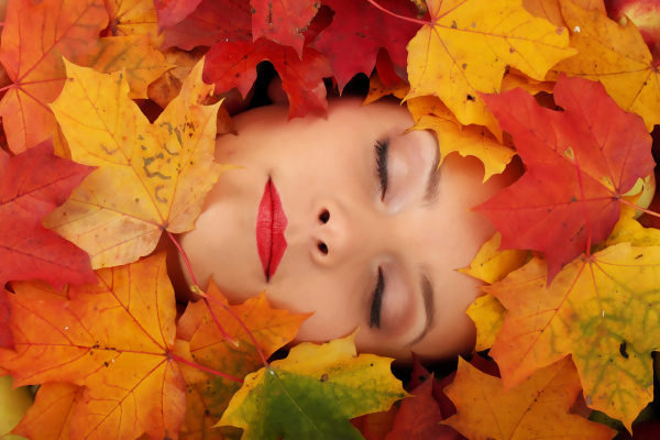 woman face in autumn leafs