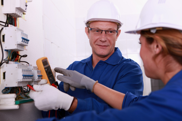 electricians working on an electric meter