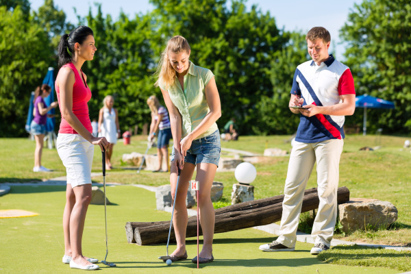 people playing mini golf in summer
