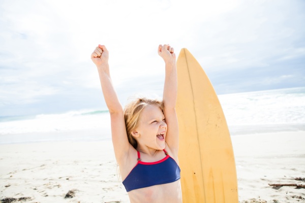 happy young girl with surfboard on