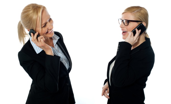 businesswomen communicating via mobile phones