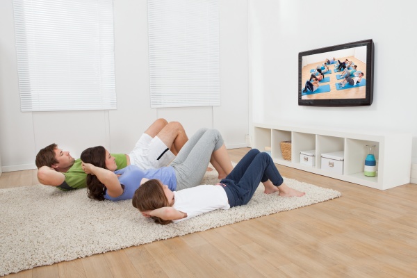 family doing situps while watching tv