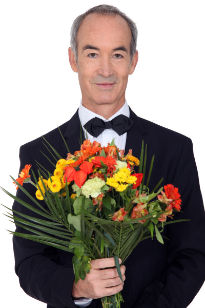 senior gentleman holding bouquet