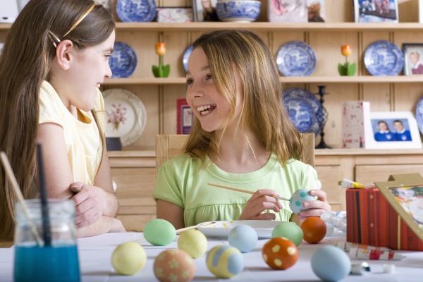young girls decorating easter eggs