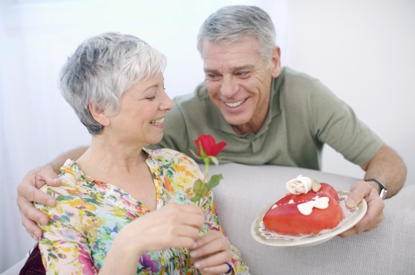 senior man romancing woman with valentine