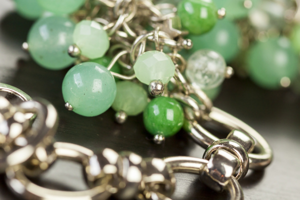 silver necklace bracelet with green gemstones