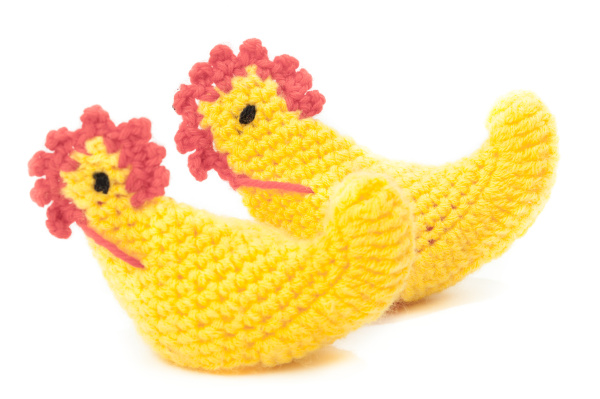 two yellow knitted easter chicken isolated