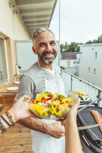 portrait of smiling man barbecuing on