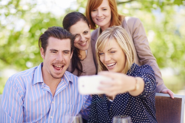 happy friends taking selfie outdoors