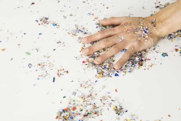 hand covered with confetti