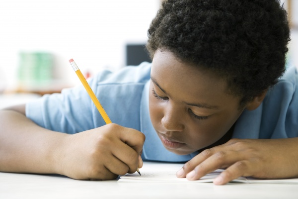 male elementary school student concentrating on