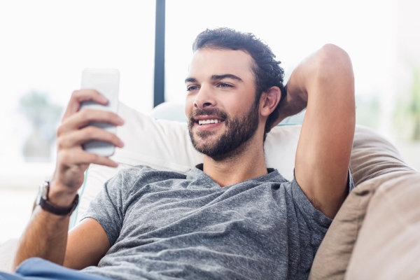 attractive man using smartphone