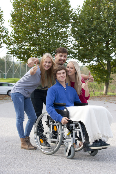 young man in wheelchair with friends