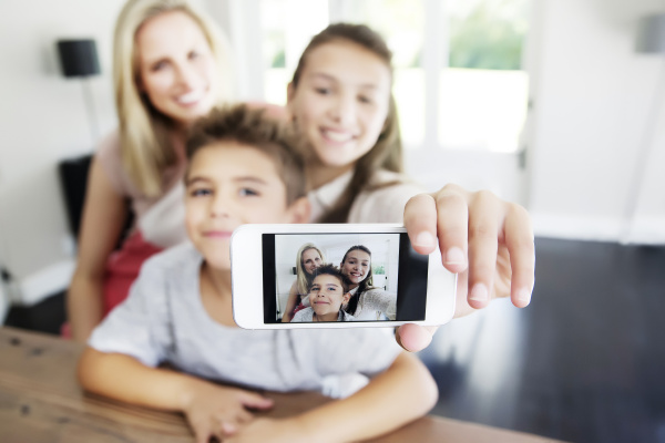 family taking selfie with smart phone