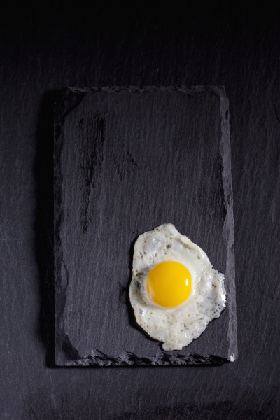 fried quail egg on slate