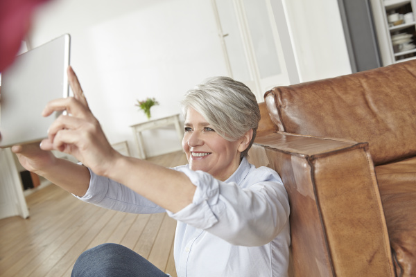 mature woman at home taking selfie