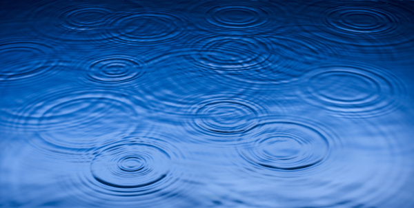 ripples of raindrops in puddle