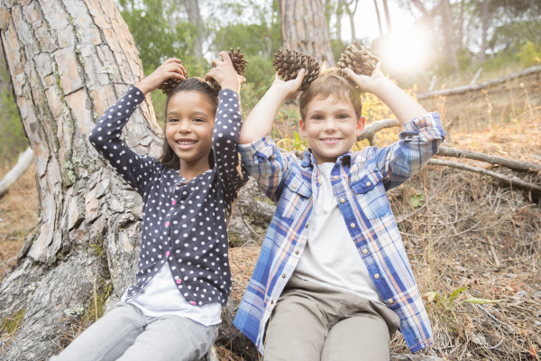 children playing with pine cones in