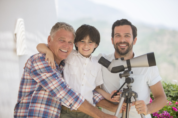multi generation men using telescope outdoors