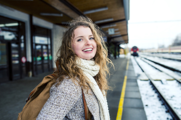 smiling teenage girl on station platform