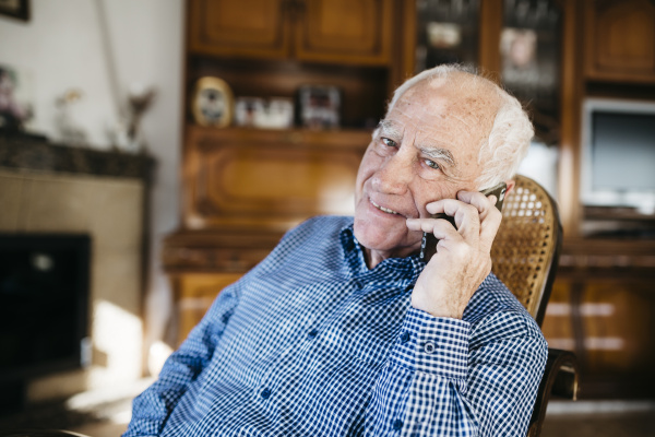 portrait of smiling senior man telephoning