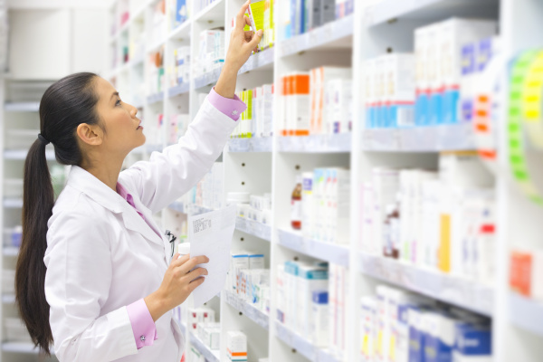 pharmacist holding prescription looking