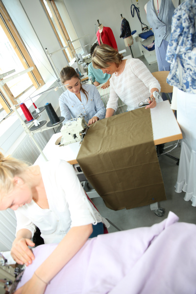 woman in dressmaking class helping student