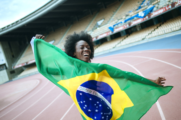 young black athlete in stadium carrying