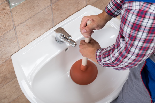 using a plunger on a bathroom sink