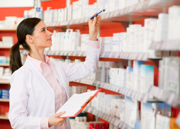 pharmacist browsing medicine on shelves