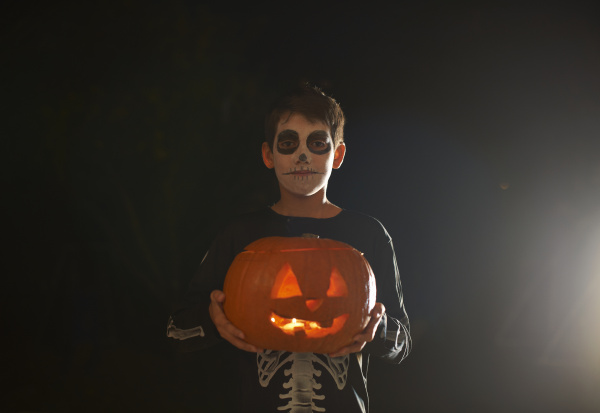 portrait of boy wearing halloween skeleton