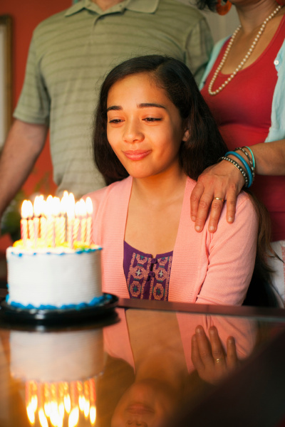 girl looking at birthday cake