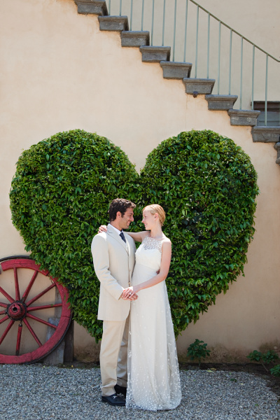 newlyweds by heart shaped bush