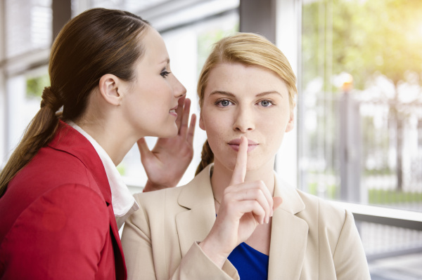 businesswomen sharing secret