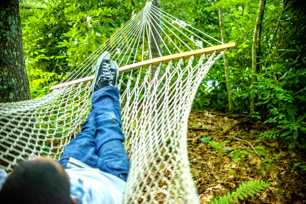 teenage boy lying in hammock