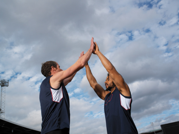 male athletes high five