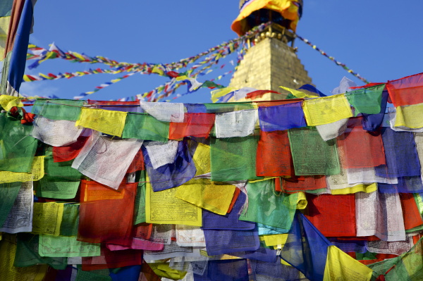 prayer flags in front of boudha