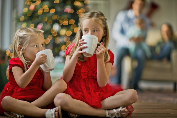 two young girls drinking hot chocolates