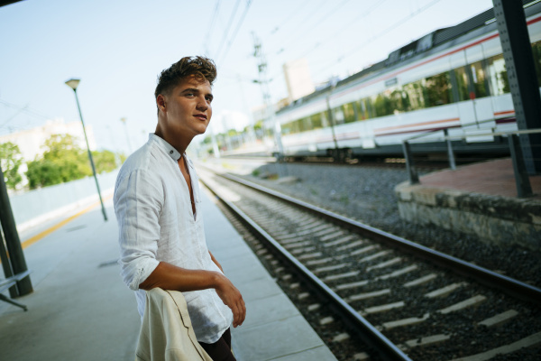 young man waiting at station platform