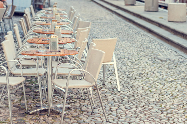 row of little tables with chairs