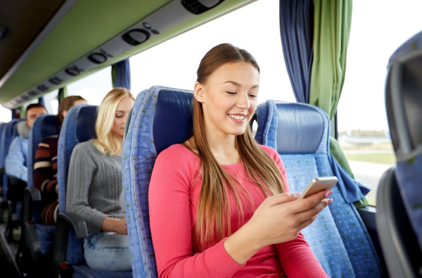 happy woman sitting in travel bus